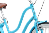 Close-up of a turquoise bicycle with a brown seat on a white background